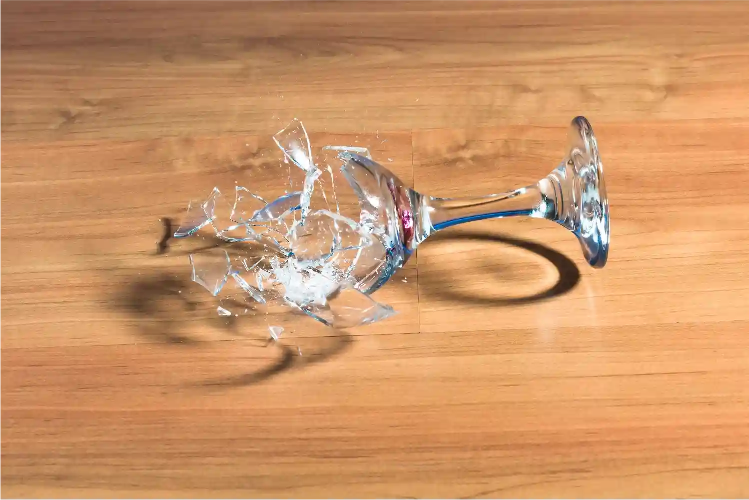 broken-glass-on-wooden-table