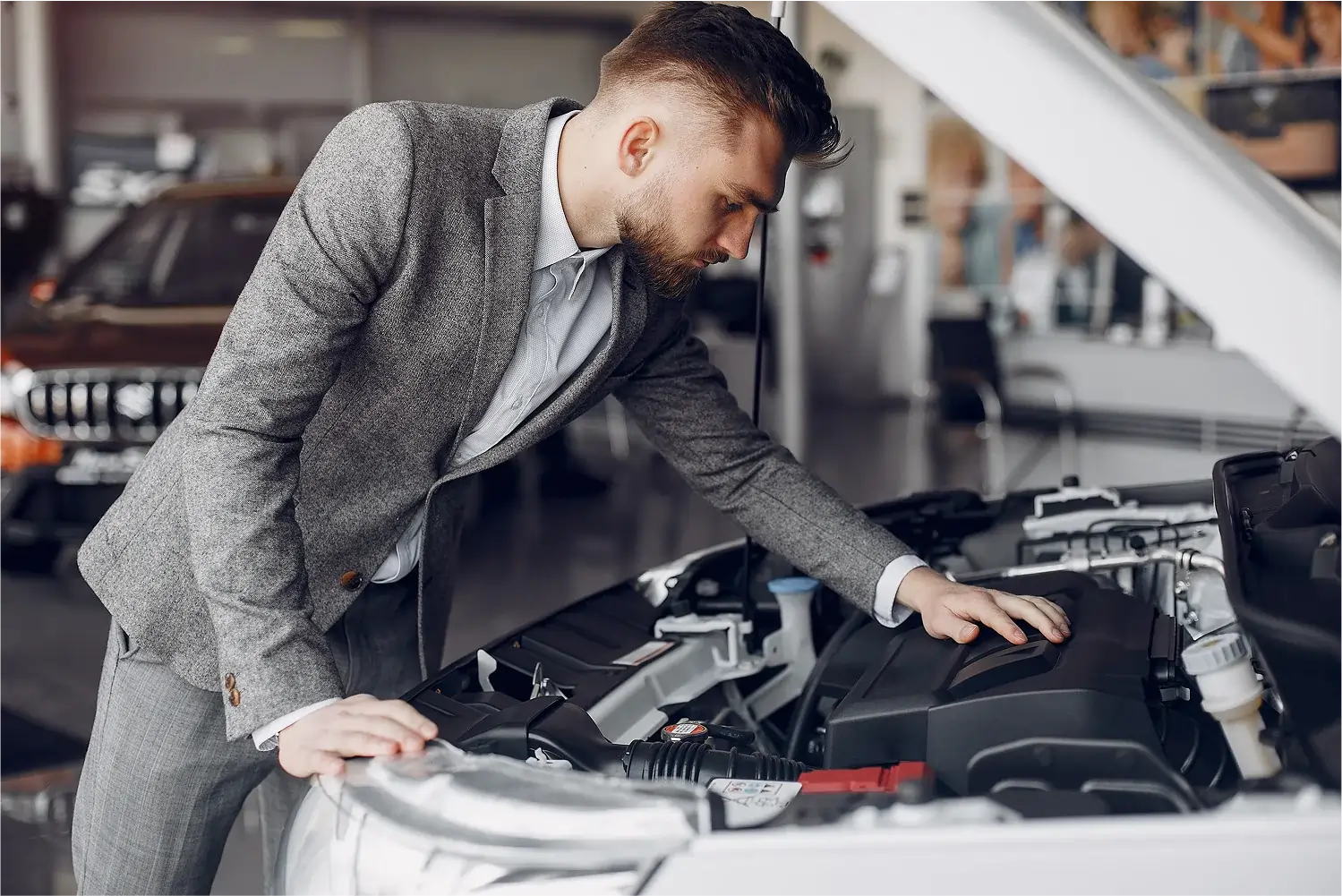 gray-coat-man-checking-car-engine