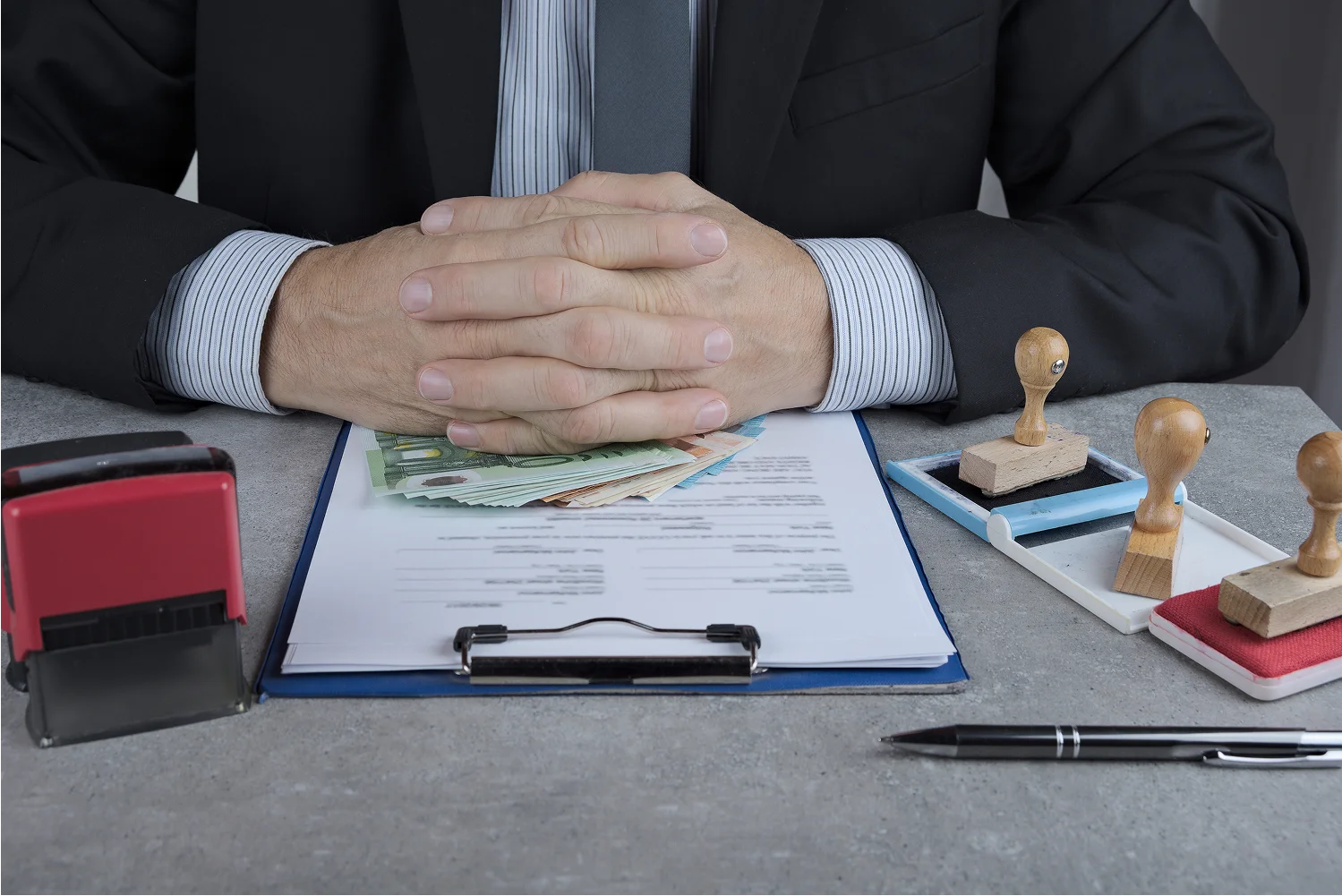 man-holding-money-with-papers