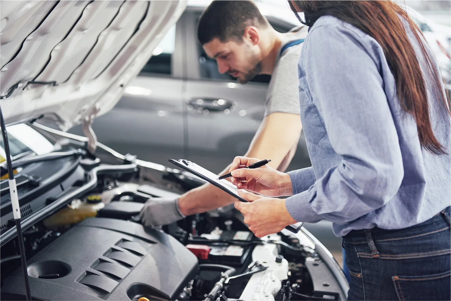 staff-checking-car-lady-making-notes